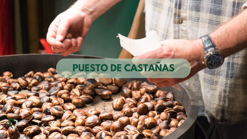 Puestos de castañas Vendedor de asando castañas en un puesto